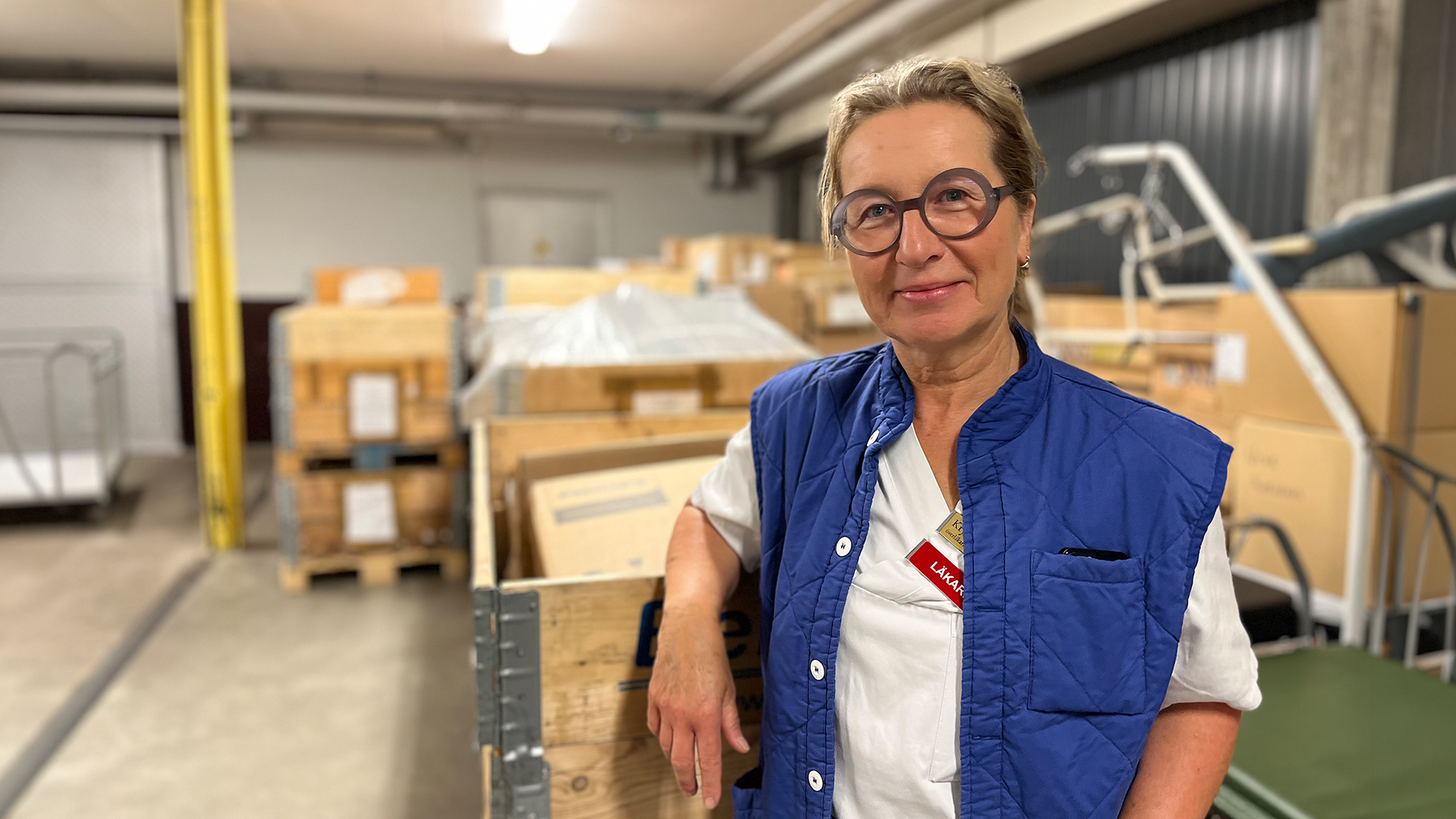 Läkare står framför träcontainrar